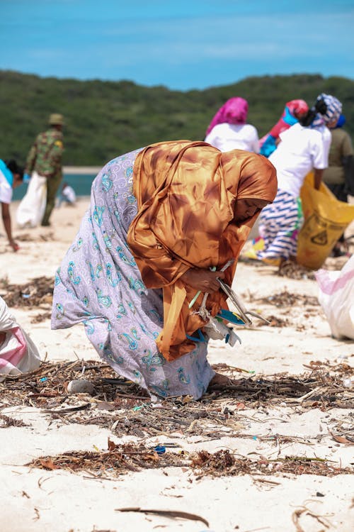 Woman Cleaning Beach from Rubbish