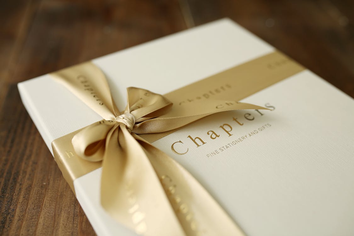 Cream-colored journal with a gold ribbon and 'Chapters' embossed on the front cover.