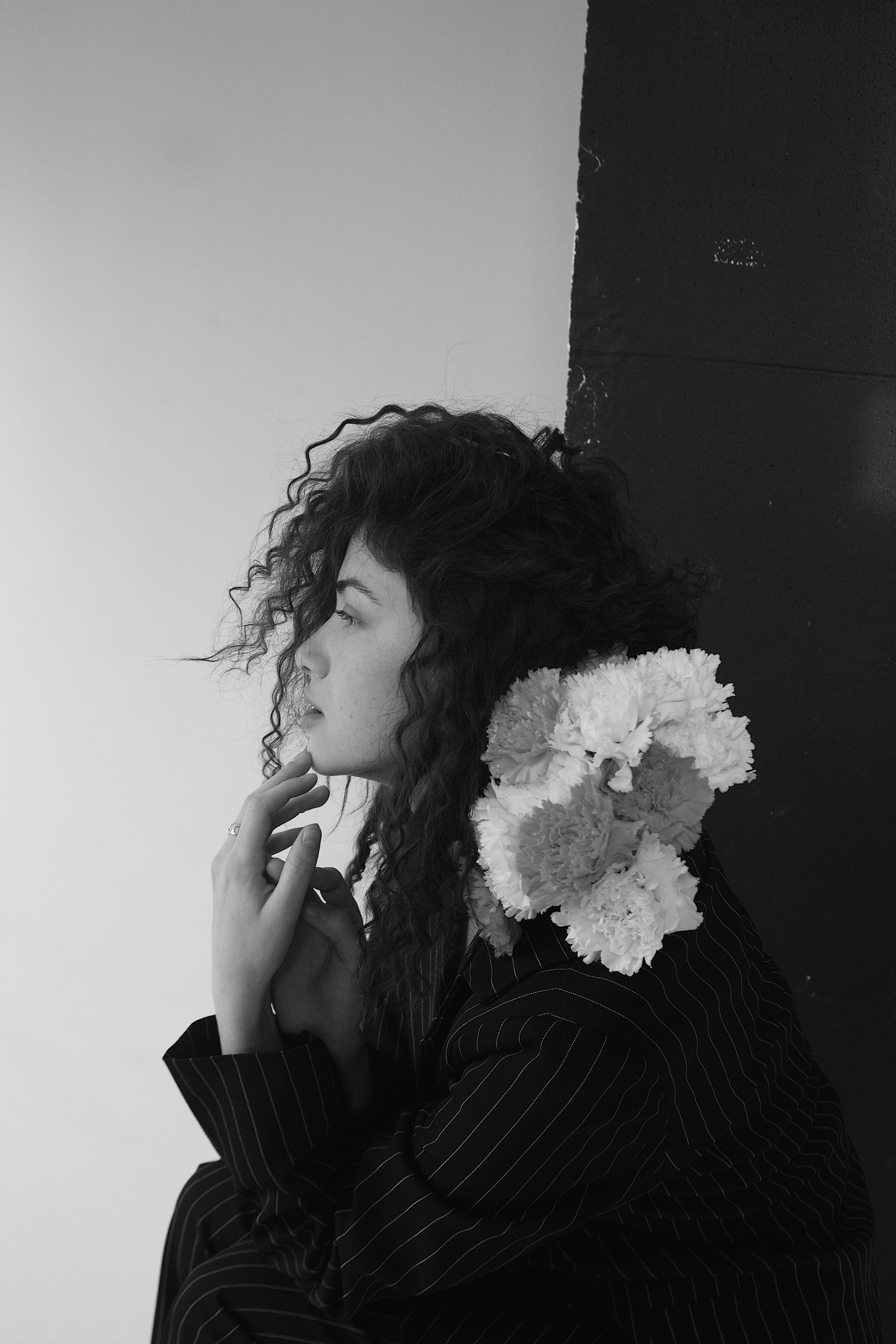 profile view of attractive brunette woman with curly long hair