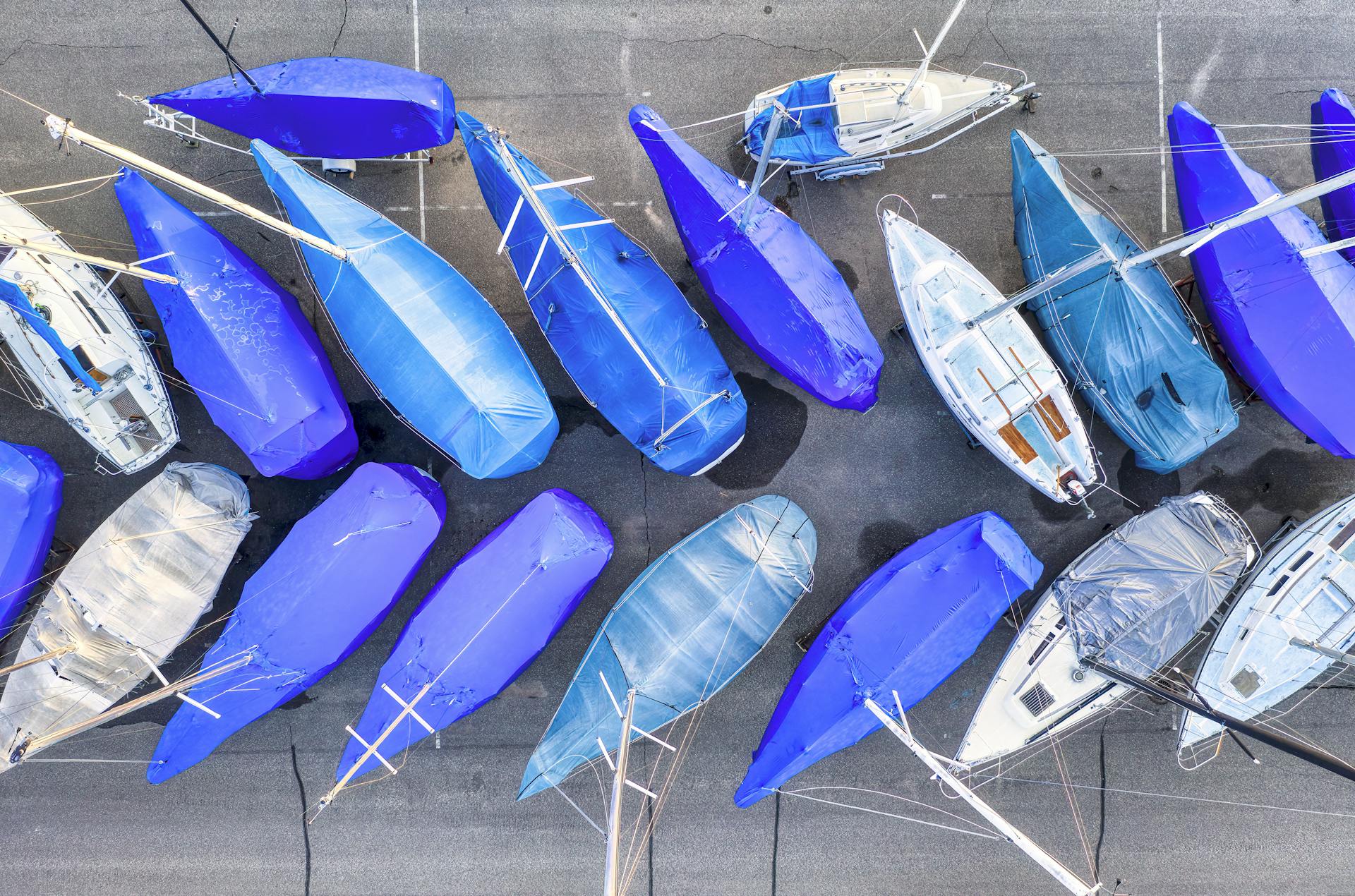 Overhead shot of moored yachts with bright blue coverings in Lake City marina, Minnesota.