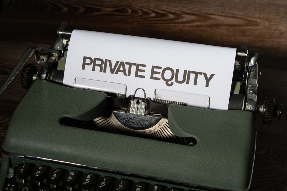 Close-up of a vintage typewriter with paper displaying 'Private Equity', symbolizing advanced financial valuation.