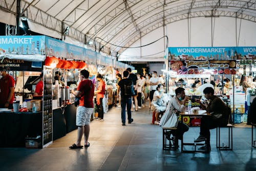 People Inside a Building with Food Stalls