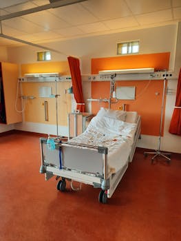 A contemporary hospital room featuring an adjustable bed and medical equipment.