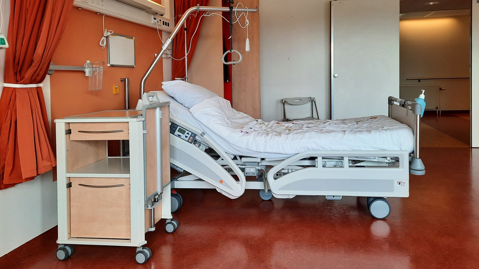 Adjustable medical bed and bedside equipment in a care room