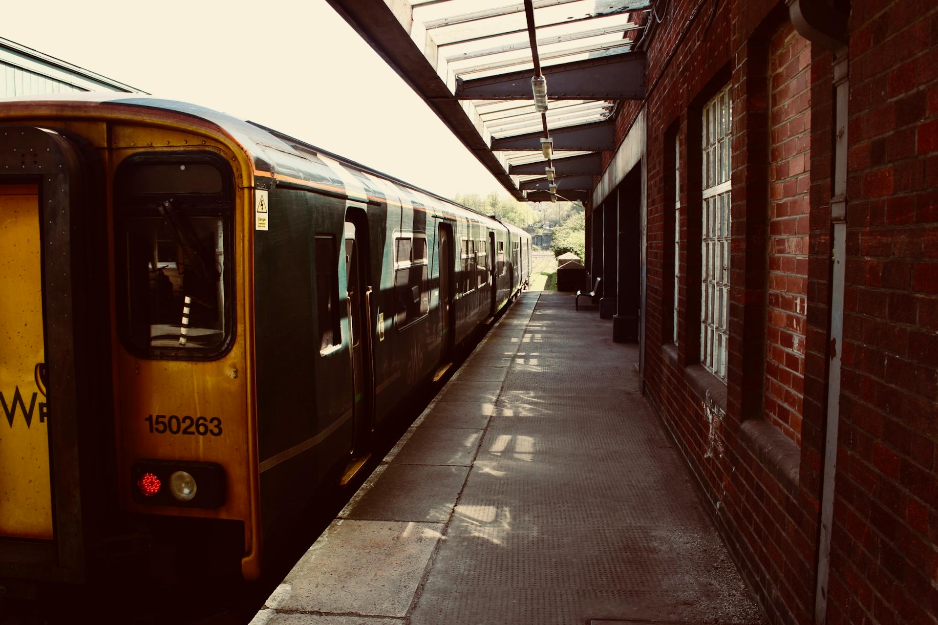A vintage train at a classic Bristol railway station, showcasing urban transportation charm.