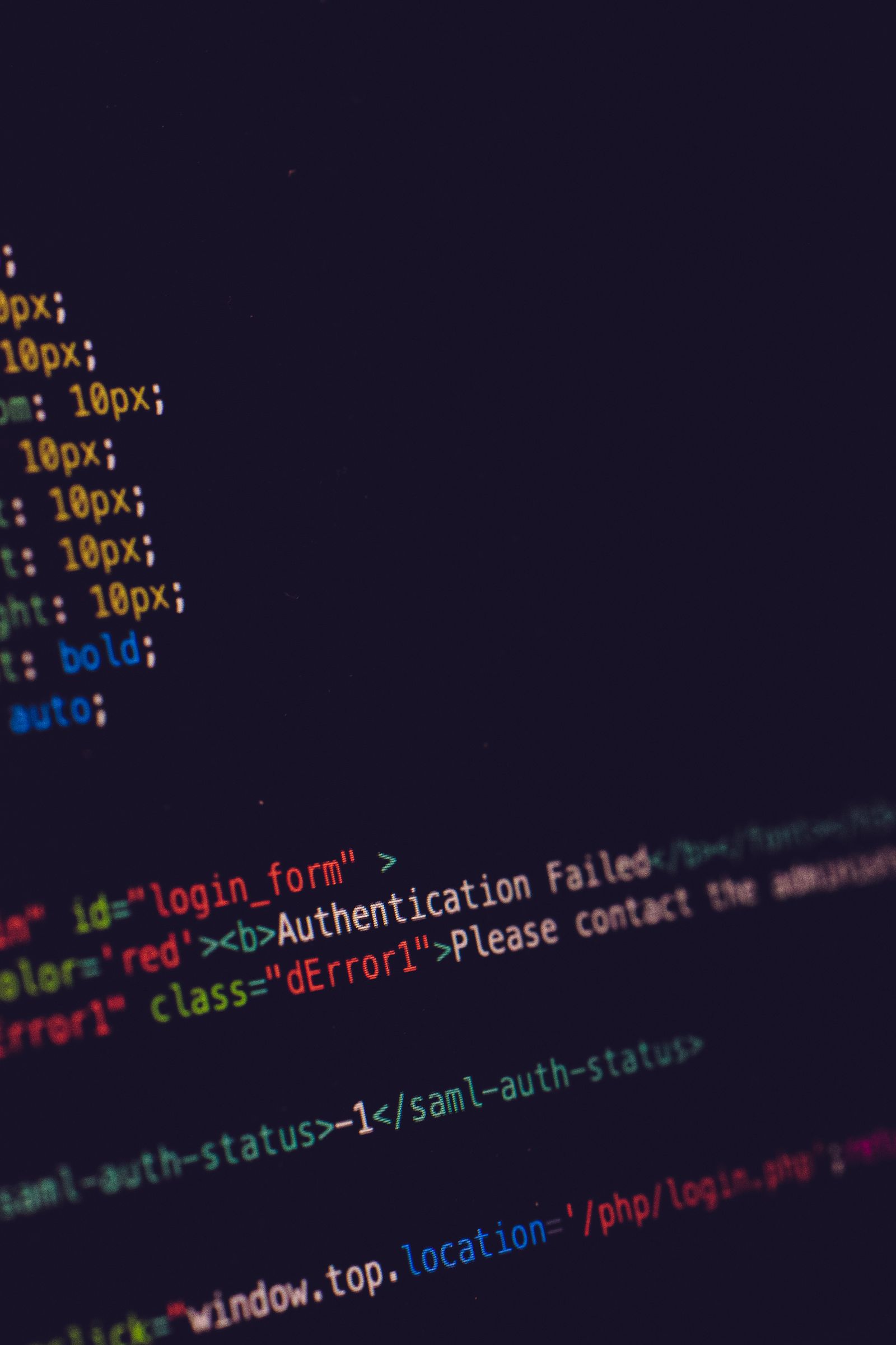 Close-up of programming code on a dark screen