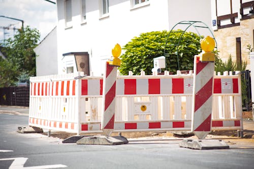 Red and White Road Barriers on the Street