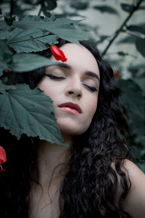 Free Woman With Red Lipstick Holding Green Leaves Stock Photo