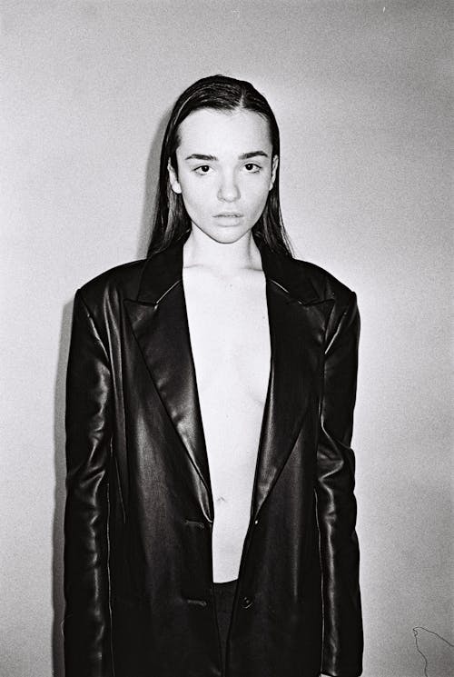 Young Woman in Black Leather Jacket Covering Breasts