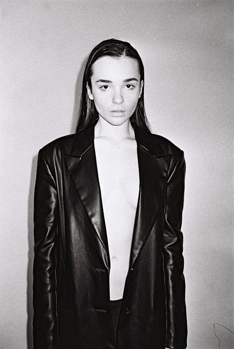 Young Woman In Black Leather Jacket Covering Breasts