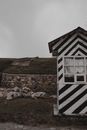 White and Black Wooden House on Green Grass Field