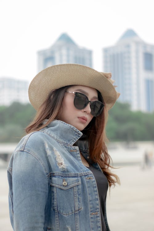 A Woman in Blue Denim Jacket Wearing a Sun Hat