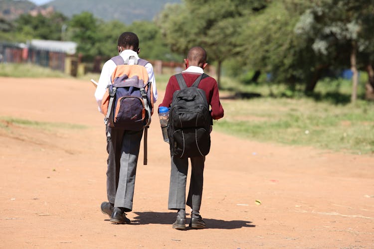 Students Walking On Unpaved Road