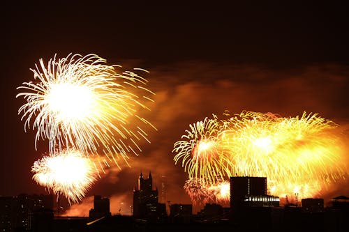 Free Fireworks Display over City Buildings during Night Time Stock Photo