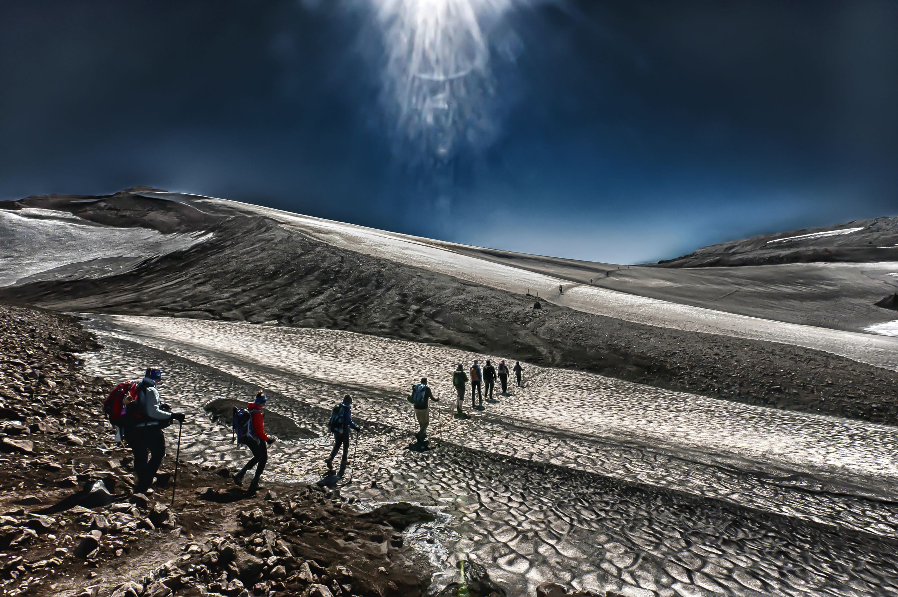 Ultimate Affordable 6 Days Kilimanjaro Climbing Tour via Marangu Route Review 2026 - Hikers traverse Iceland's dramatic glacier landscapes under a striking sky, showcasing adventure.