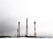 Red and White Tower Under Cloudy Sky
