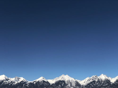 Snow Covered Mountain Ranges Under Blue Sky