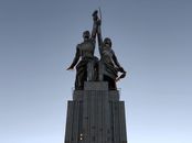 Gray Concrete Building with Statue on Top Under the Blue Sky