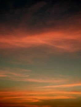 A captivating sunset sky, displaying vibrant hues and dramatic cloud formations, perfect for backgrounds.