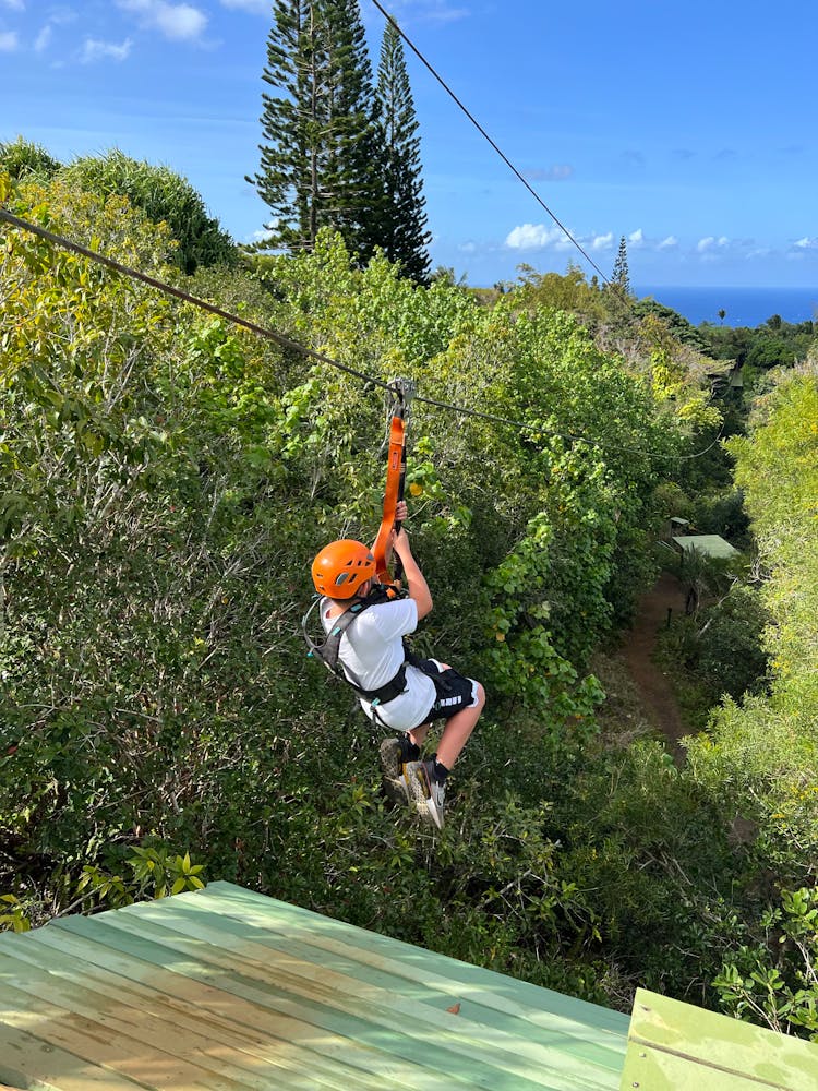 A Person Sliding On The Zipline