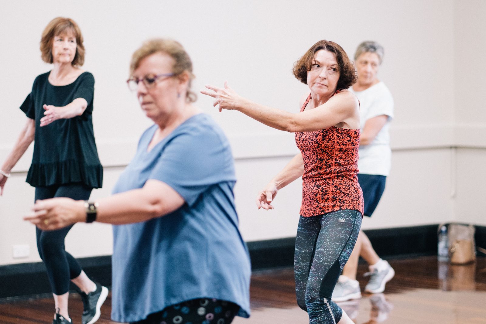 Instructor leading a lively Zumba dance class set to Latin rhythms