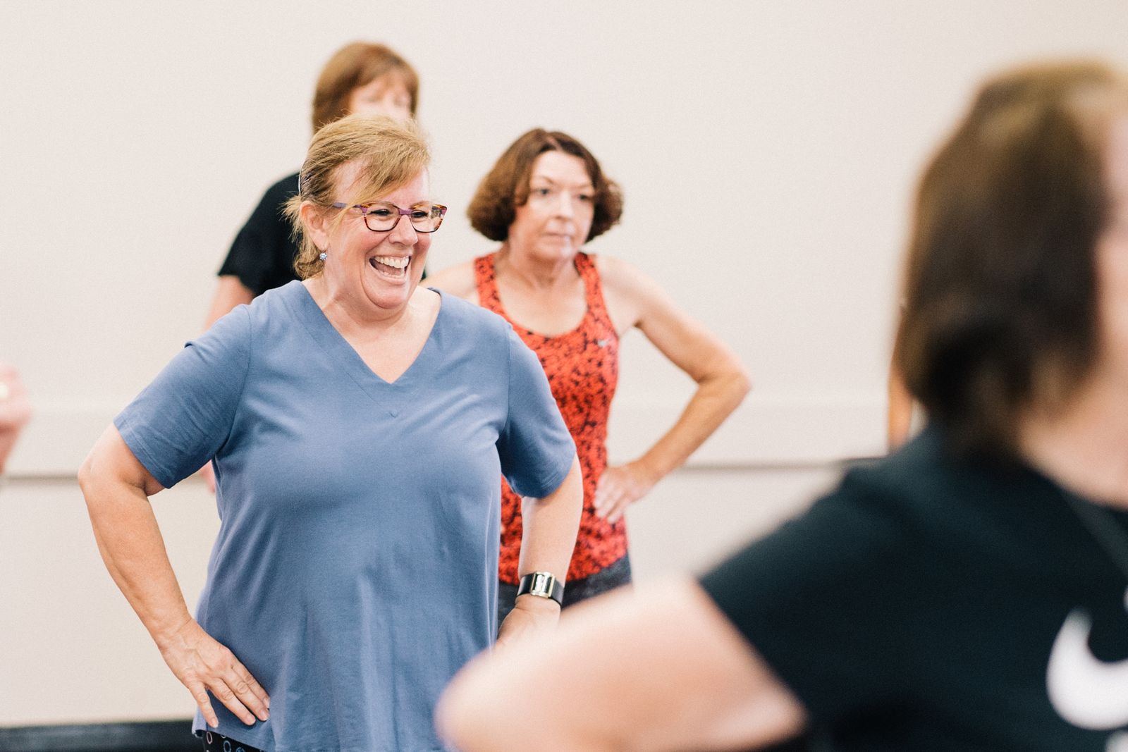 Diverse group dance class laughing together during a fitness session