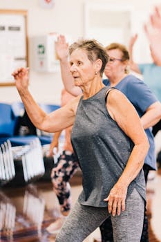 Group of senior women dancing energetically in a fitness class promoting a healthy lifestyle.
