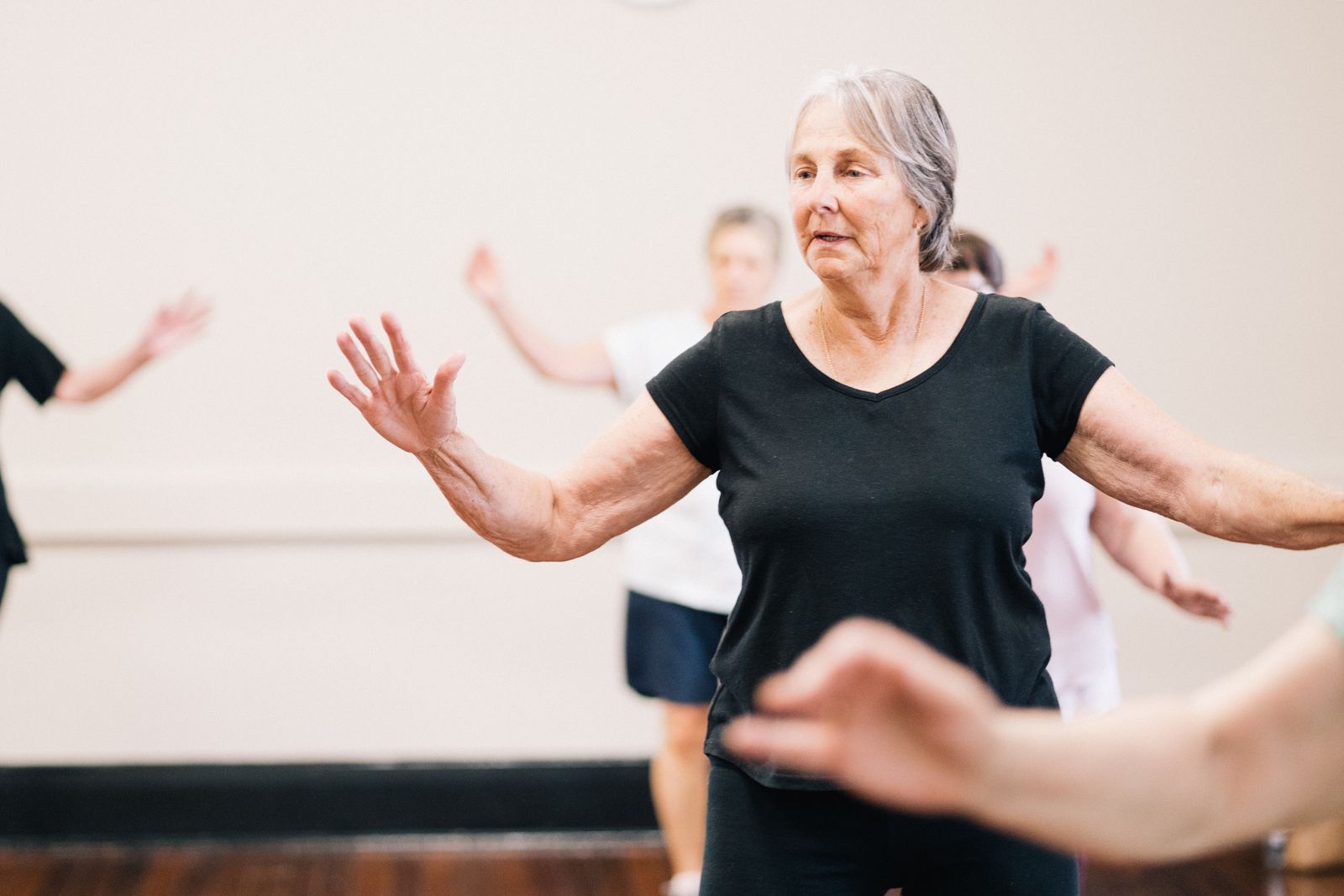 A group of older women enjoying an indoor fitness class together