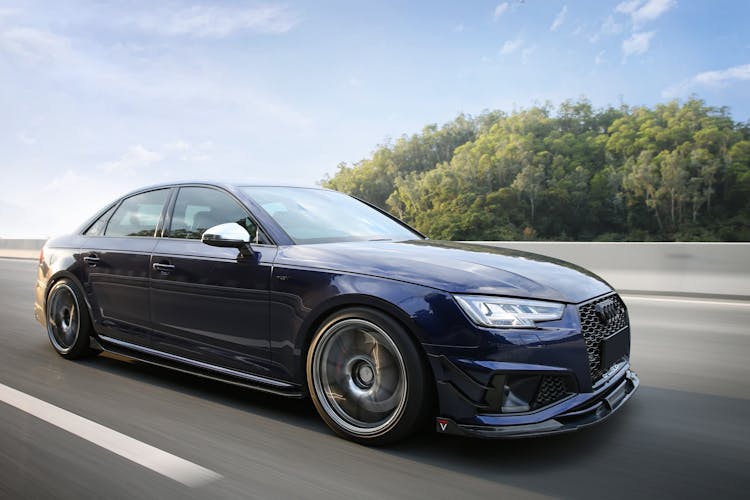 Navy Blue Car On A Highway