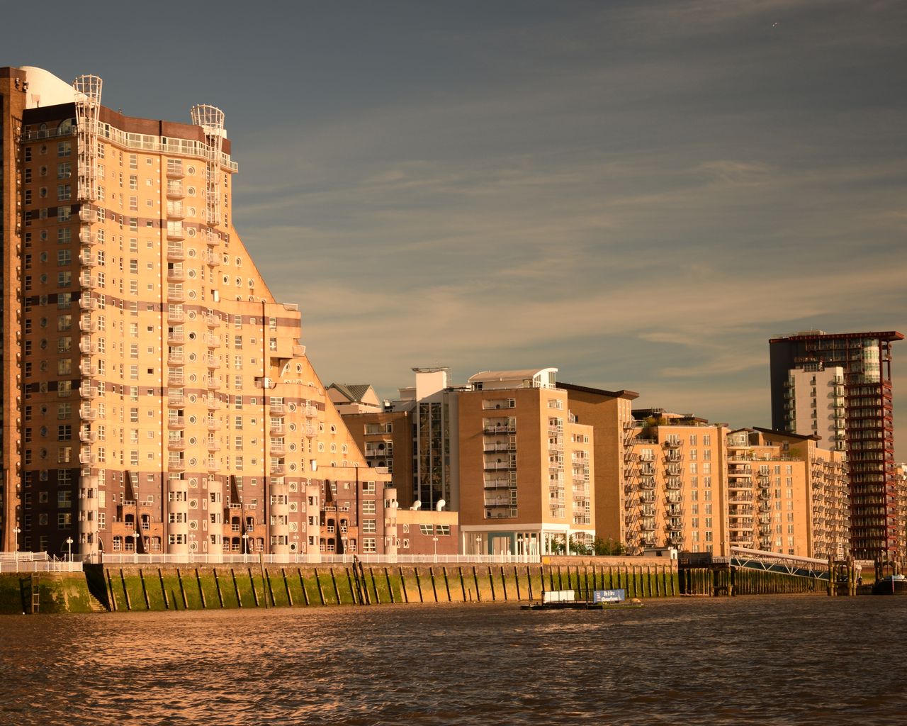 Riverside London apartment buildings in warm evening light