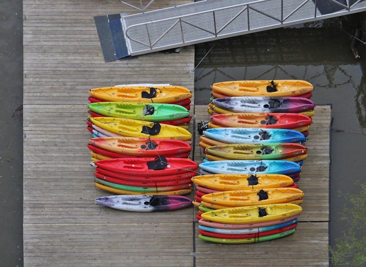 Colorful Canoes On Wooden Dock