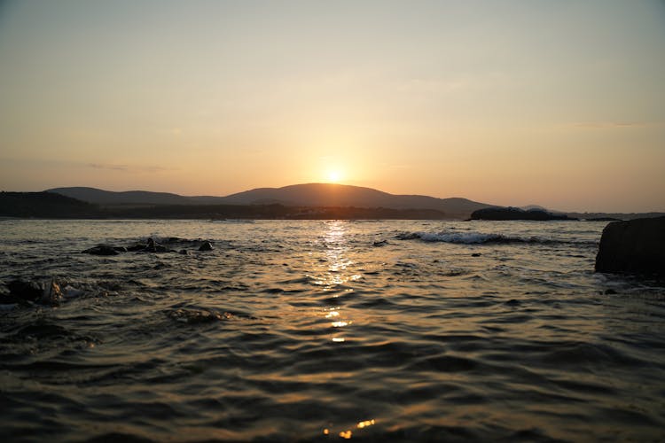 Sun Setting Over Sea Shore