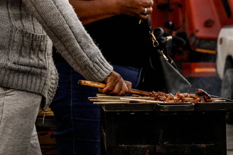 A Person Grilling Meat 