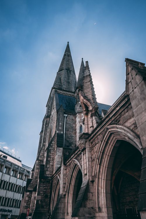 Free A striking view of a Gothic cathedral's spire in Dublin under a clear sky. Stock Photo