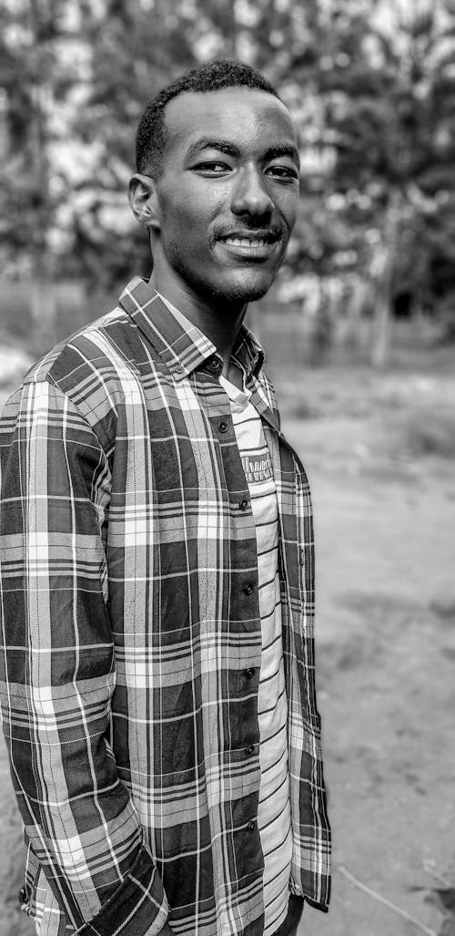 Black and White Portrait of Smiling Man in Checked Shirt