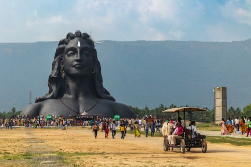 Free A vibrant scene at the Adiyogi Shiva statue with visitors and lush mountain backdrop in Booluvampatti, India. Stock Photo