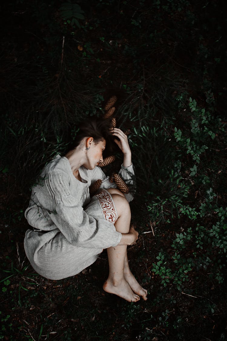 Woman Lying On The Ground In Fetal Position 