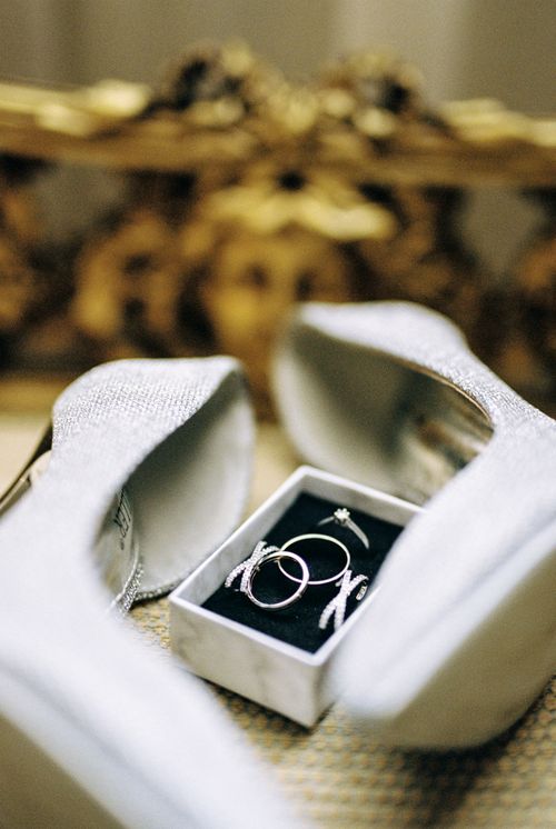 Free Close-up of elegant wedding rings and shoes in a glossy studio setting, perfect for bridal themes. Stock Photo