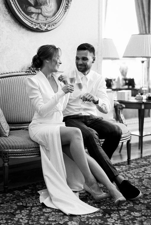 Free Charming black and white image of newlyweds celebrating indoors with champagne. Stock Photo