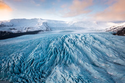 A breathtaking view of a glacier in Iceland at sunrise, showcasing its intricate ice patterns.