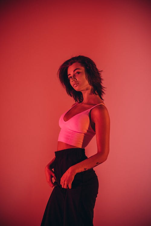 Woman Posing under Red Studio Light