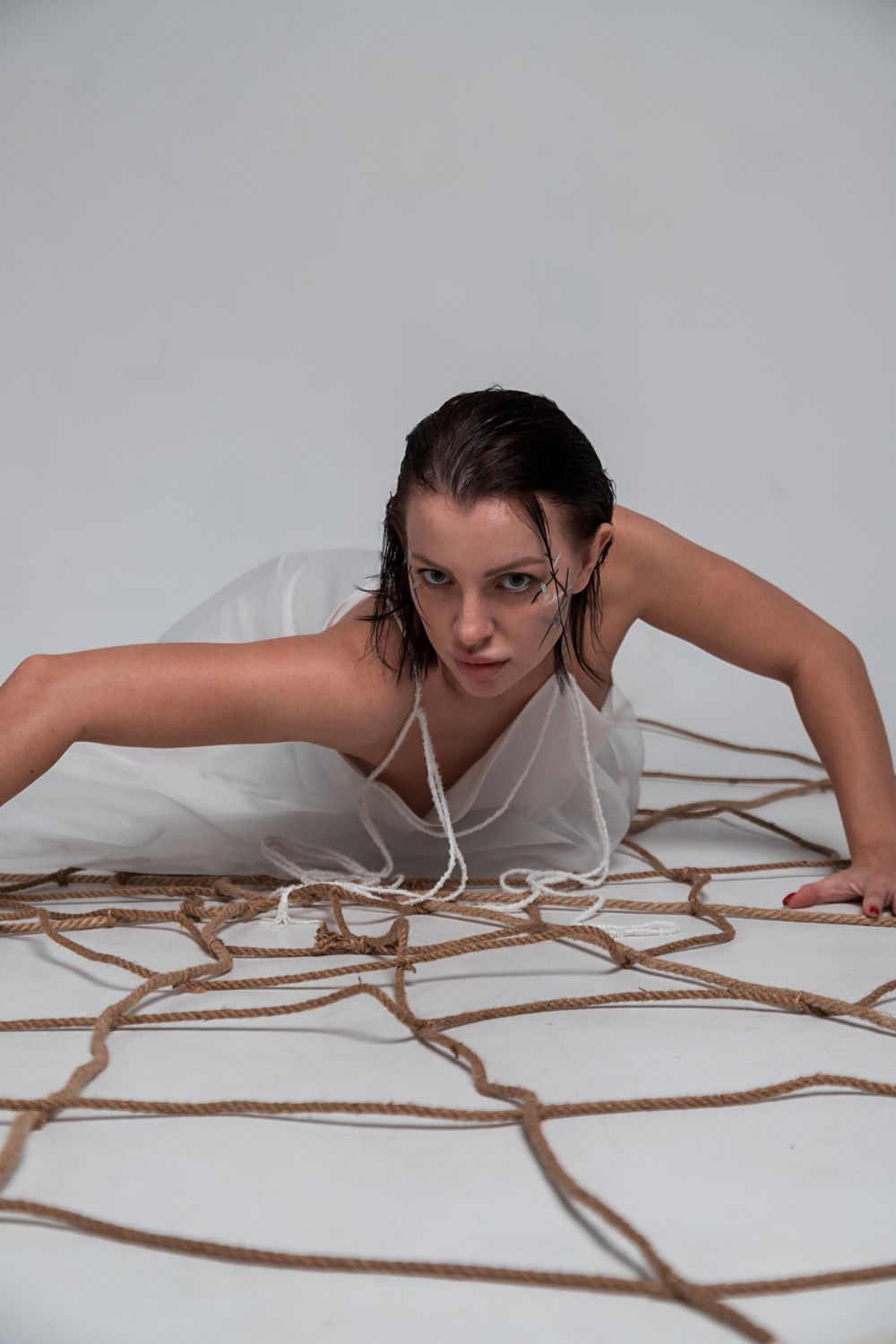 Long Rope Spread Out Woman Lying on Rope Net Spread on Floor · Free Stock Photo