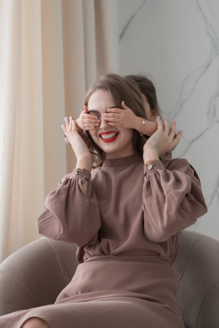 Woman Having Her Eyes Covered By Her Daughter 