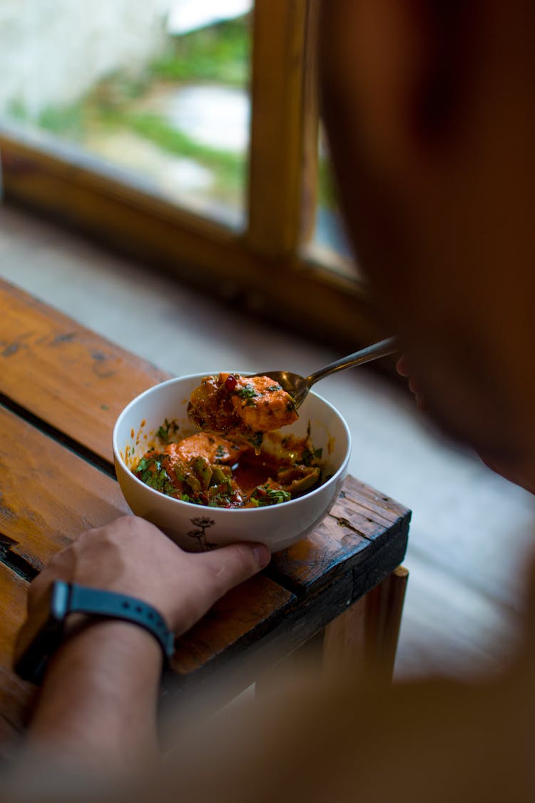 Person Eating  Stew In White Ceramic Bowl 