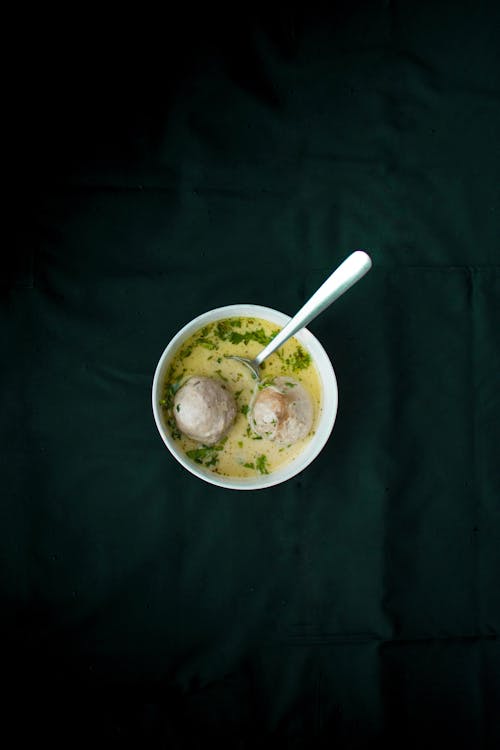 Top View of a Bowl of Soup on a Black Tablecloth