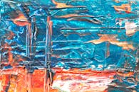 这幅色彩缤纷的抽象丙烯画，带有生动的绿松石与橙色纹理