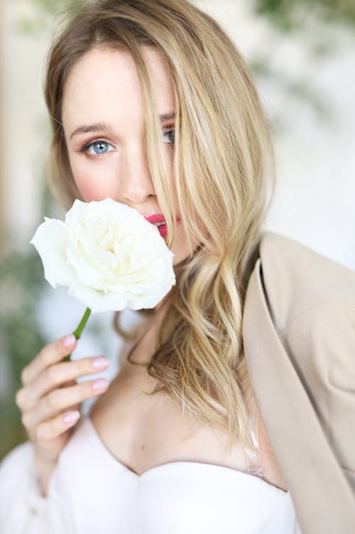 Portrait pf Blonde Woman Holding a White Rose