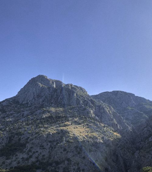 Free Scenic view of rugged mountain peaks against a bright blue sky in Montenegro. Stock Photo