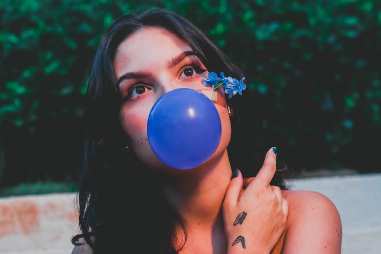 Woman Blowing Blue Balloon 