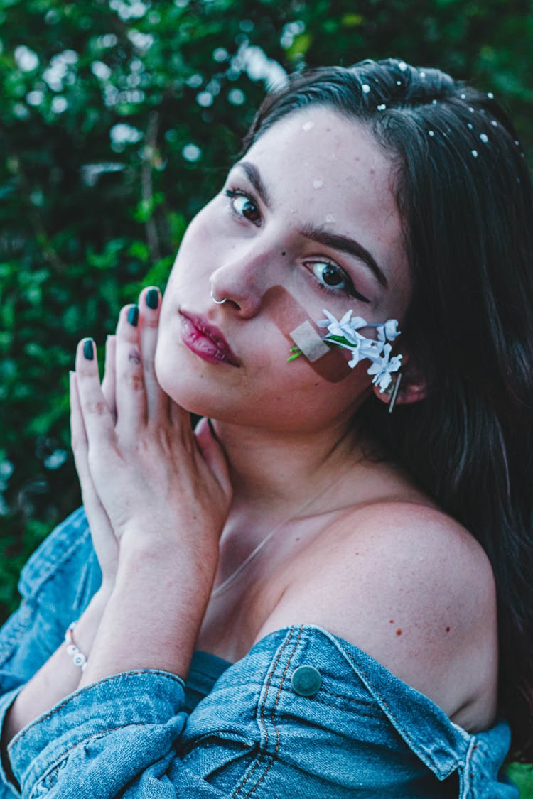 A Woman In Denim Clothes With Band Aid And Flowers On Her Face